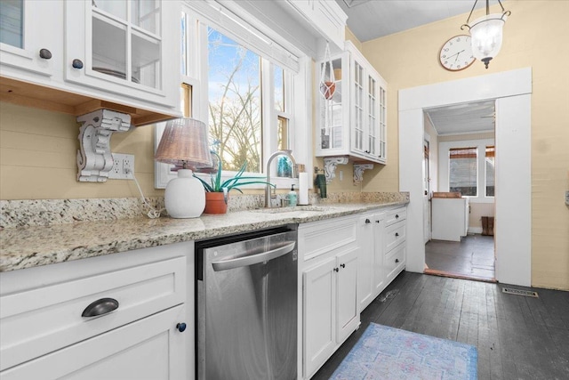 kitchen with pendant lighting, sink, dark hardwood / wood-style floors, white cabinets, and stainless steel dishwasher