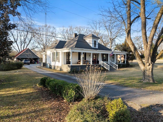 view of front of property with covered porch and a front lawn