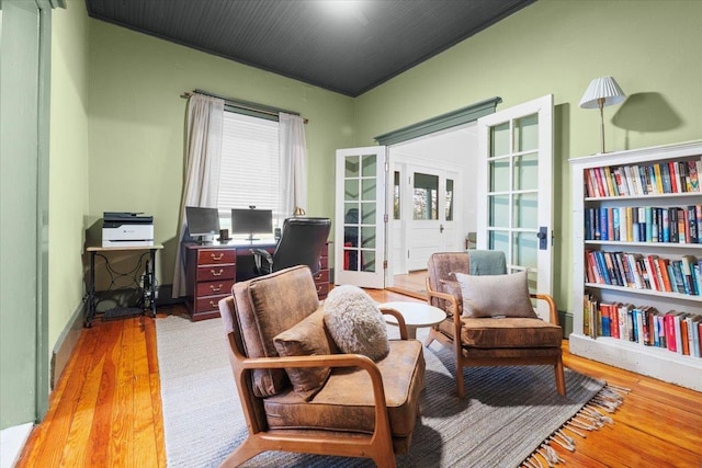 sitting room featuring french doors and light wood-type flooring