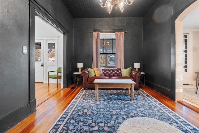 sitting room with hardwood / wood-style flooring and a chandelier