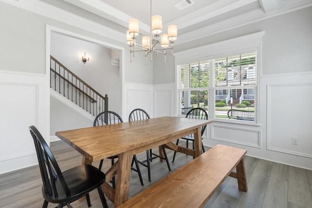 dining area featuring hardwood / wood-style floors and a chandelier