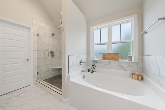 bathroom featuring lofted ceiling and shower with separate bathtub