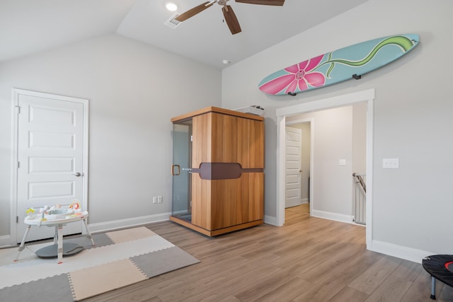 interior space featuring vaulted ceiling, ceiling fan, and light wood-type flooring