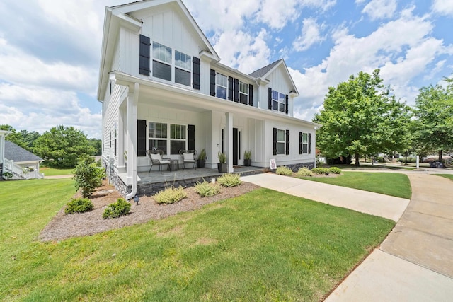 view of front of house with covered porch and a front lawn