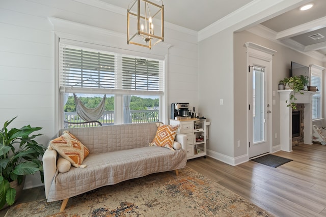 living area with ornamental molding, wooden walls, a chandelier, and wood-type flooring