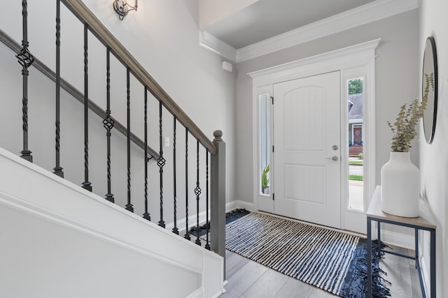 entryway with crown molding and light wood-type flooring