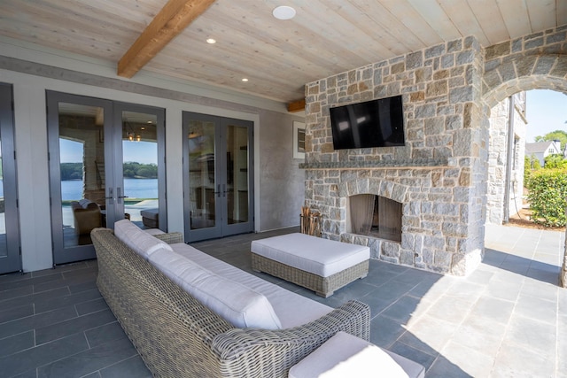 view of patio featuring french doors and an outdoor stone fireplace