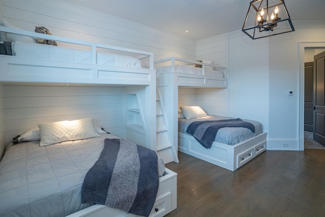 bedroom featuring dark hardwood / wood-style flooring and a notable chandelier