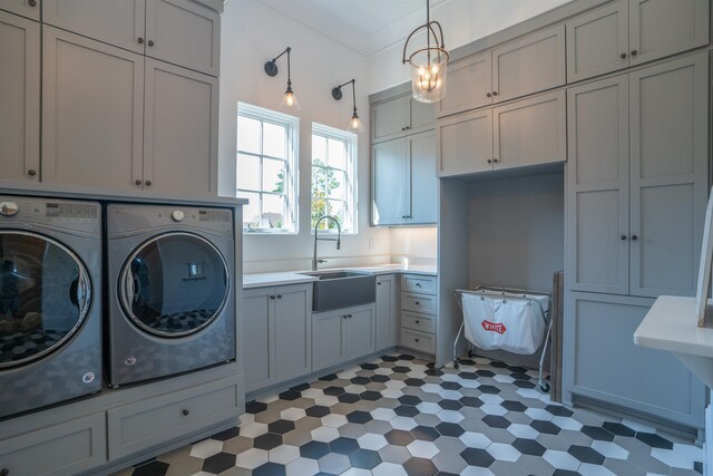 laundry area featuring crown molding, cabinets, separate washer and dryer, and sink