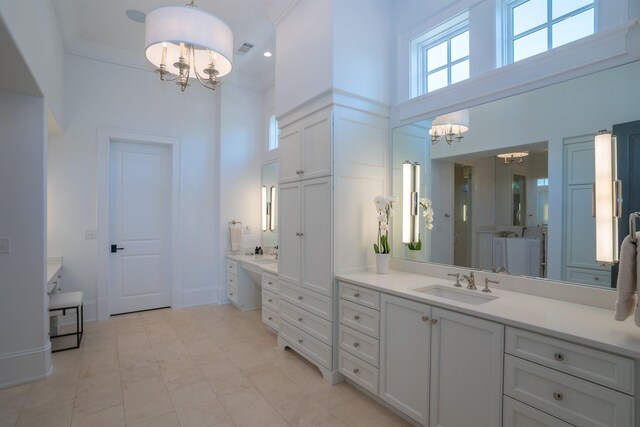 bathroom featuring an inviting chandelier, vanity, crown molding, and a high ceiling