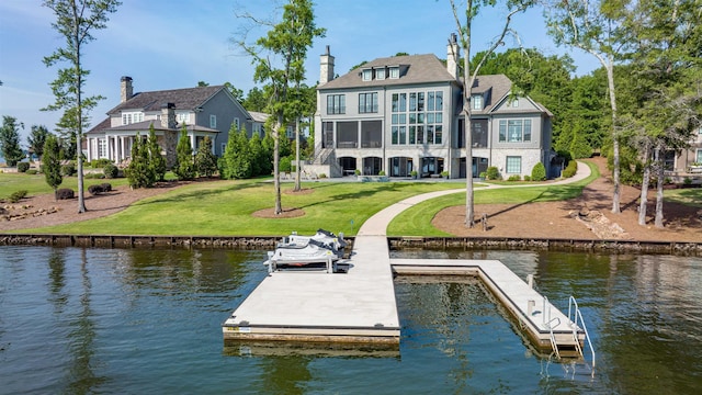 view of dock with a water view and a yard