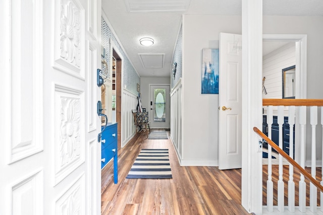 150 Possum Point Dr, Eatonton, GA 31024 - corridor with attic access, light wood-style flooring, an upstairs landing, baseboards, and a textured ceiling