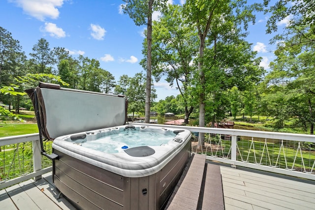 150 Possum Point Dr, Eatonton, GA 31024 - deck featuring a hot tub and view of wooded area