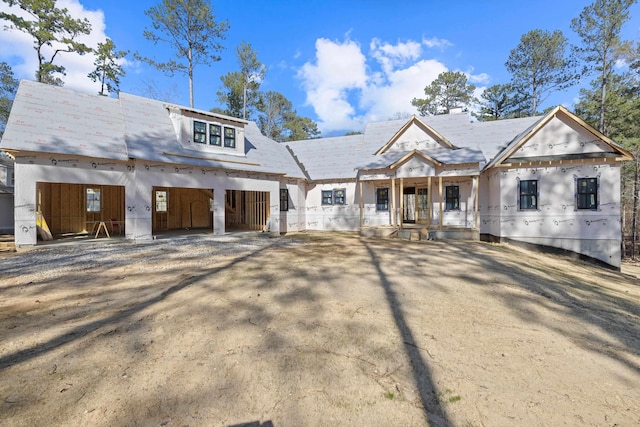 property under construction featuring dirt driveway