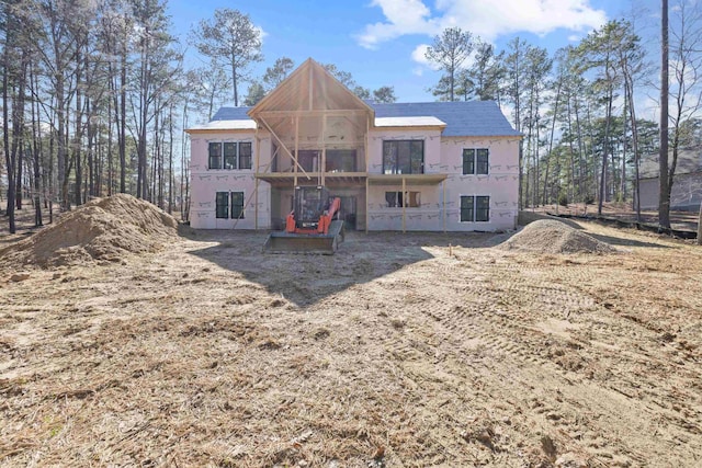 rear view of house with stucco siding