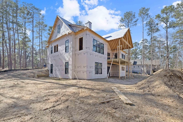 rear view of property with a chimney