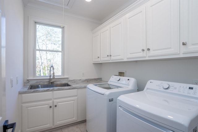 laundry room with washing machine and dryer, a sink, cabinet space, attic access, and crown molding