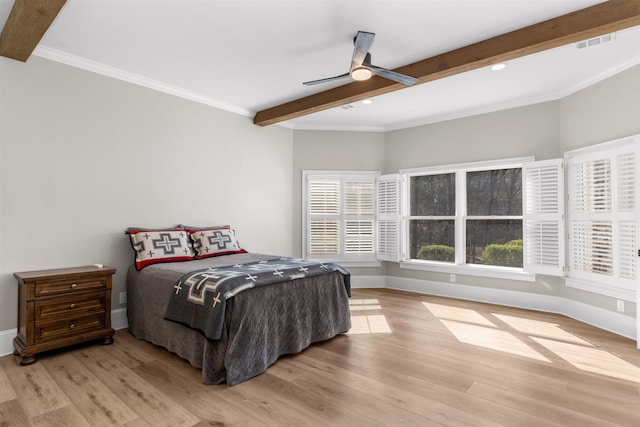 bedroom featuring light wood-style floors, beam ceiling, visible vents, and baseboards
