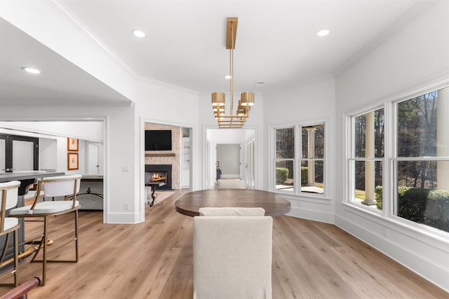 dining room with recessed lighting, crown molding, baseboards, light wood finished floors, and an inviting chandelier