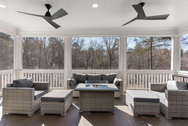 sunroom / solarium with a ceiling fan