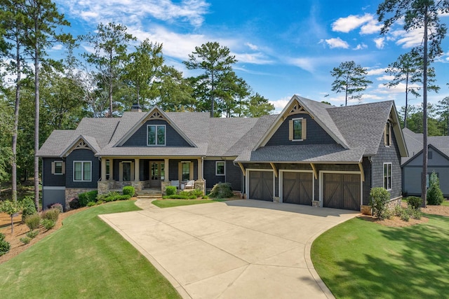 1010 Thorton Crk, Greensboro, GA 30642 - craftsman house with covered porch, driveway, a front lawn, a shingled roof, and stone siding