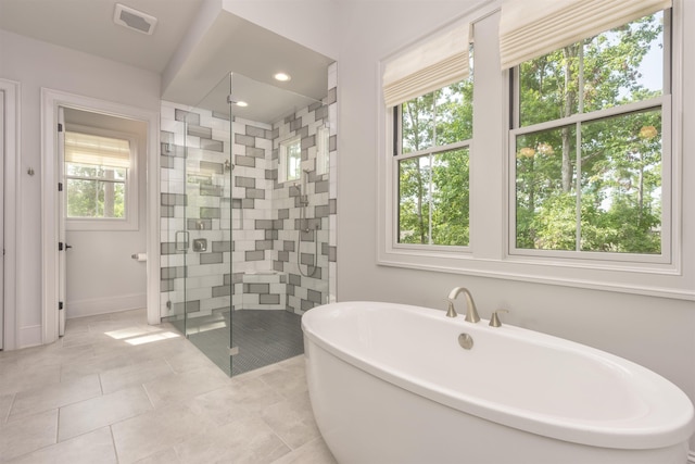 1010 Thorton Crk, Greensboro, GA 30642 - full bath with a stall shower, a soaking tub, baseboards, and tile patterned flooring