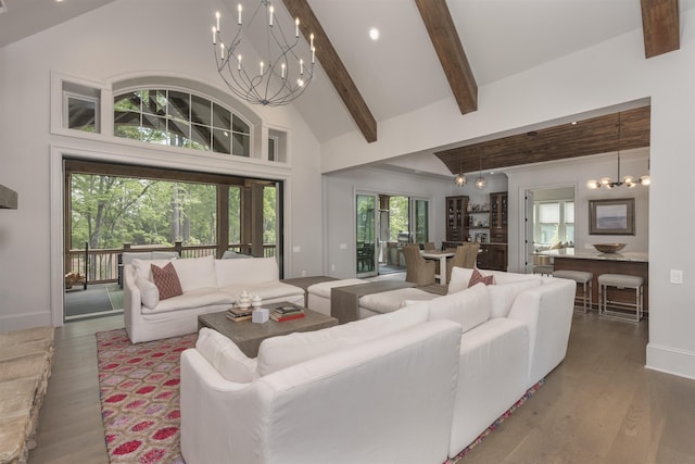 1010 Thorton Crk, Greensboro, GA 30642 - living room with a chandelier, beam ceiling, baseboards, wood finished floors, and high vaulted ceiling