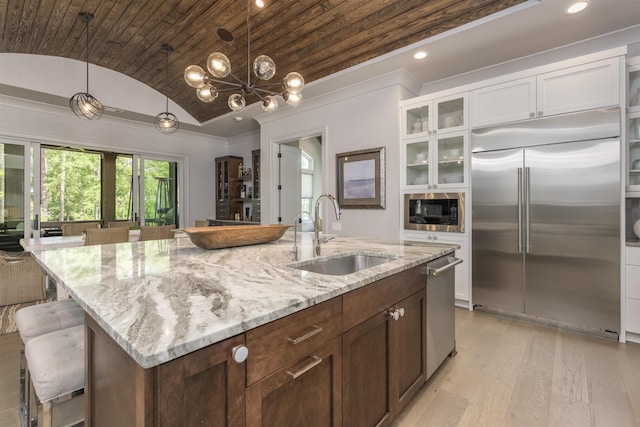 1010 Thorton Crk, Greensboro, GA 30642 - kitchen featuring built in appliances, a sink, lofted ceiling, white cabinets, and light wood-style flooring