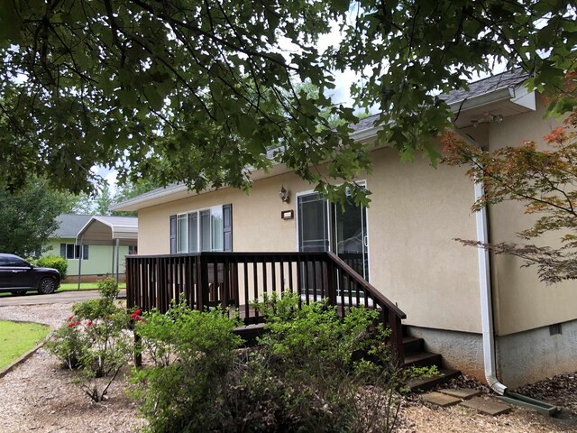 104 Wesley Ln, Eatonton, GA 31024 - view of property exterior featuring stucco siding and a carport