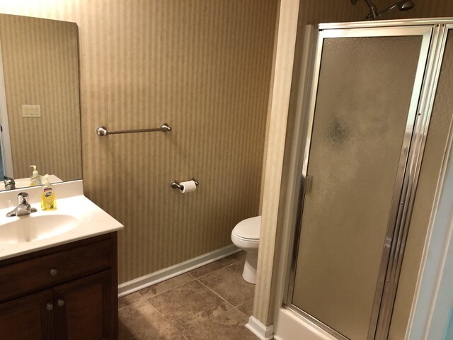104 Wesley Ln, Eatonton, GA 31024 - bathroom featuring vanity, a stall shower, toilet, tile patterned flooring, and wallpapered walls