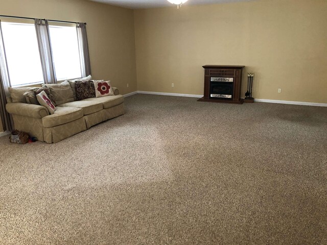 104 Wesley Ln, Eatonton, GA 31024 - living room featuring carpet, baseboards, and a fireplace