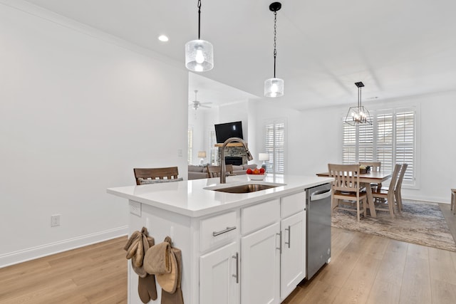 746 Markhams Dr, Madison, GA 30650 - kitchen with a sink, ceiling fan with notable chandelier, a center island with sink, a fireplace, and dishwasher