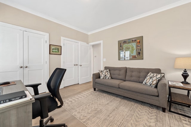 office area featuring light wood-type flooring and crown molding