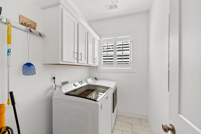 laundry area with visible vents, baseboards, cabinet space, washer and clothes dryer, and marble finish floor