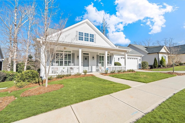 view of front facade featuring an attached garage, covered porch, a front yard, and concrete driveway