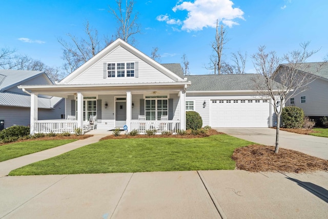 view of front of home with a front yard, an attached garage, driveway, and a porch
