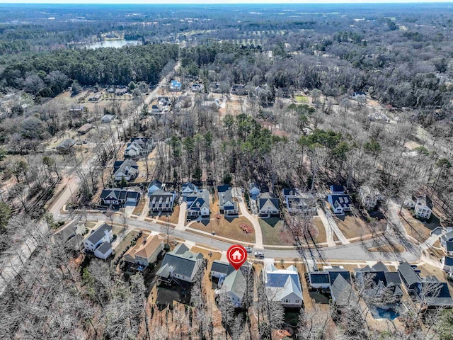 aerial view with a wooded view and a residential view
