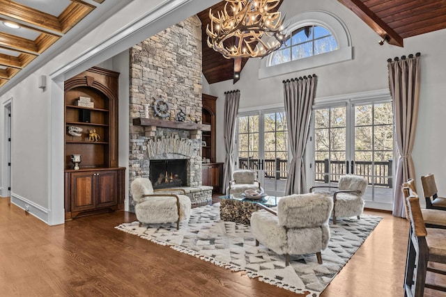 living room with a fireplace, wood-type flooring, beam ceiling, and a wealth of natural light