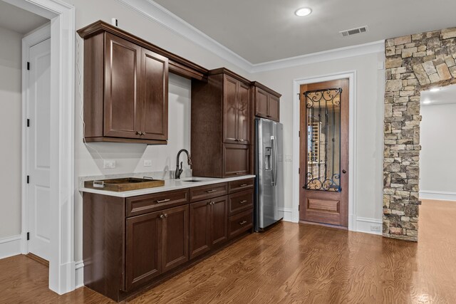 1030 Ridge Grove Ct, Greensboro, GA 30642 - kitchen featuring visible vents, a sink, dark brown cabinetry, stainless steel refrigerator with ice dispenser, and light countertops