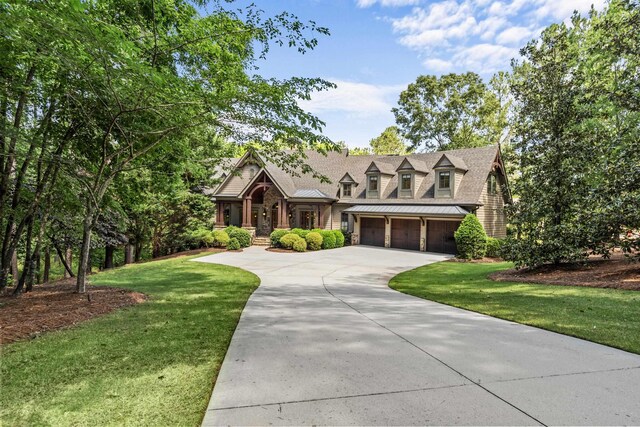 1030 Ridge Grove Ct, Greensboro, GA 30642 - view of front of house featuring a garage, a front lawn, a standing seam roof, and driveway