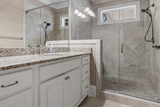 bathroom with tile patterned flooring, vanity, and an enclosed shower