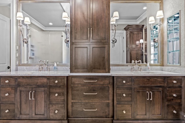 bathroom featuring a shower with door, crown molding, and vanity