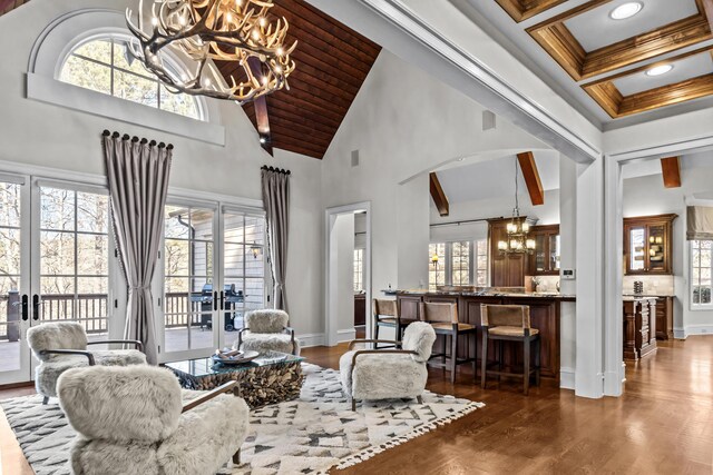 1030 Ridge Grove Ct, Greensboro, GA 30642 - living room with high vaulted ceiling, french doors, a healthy amount of sunlight, and a notable chandelier