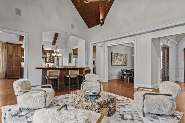 living room featuring hardwood / wood-style floors, a notable chandelier, high vaulted ceiling, and wooden ceiling