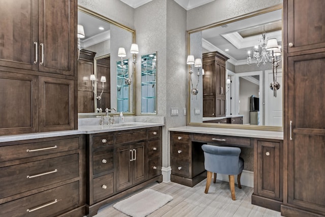 bathroom featuring a raised ceiling, ornamental molding, vanity, and an inviting chandelier