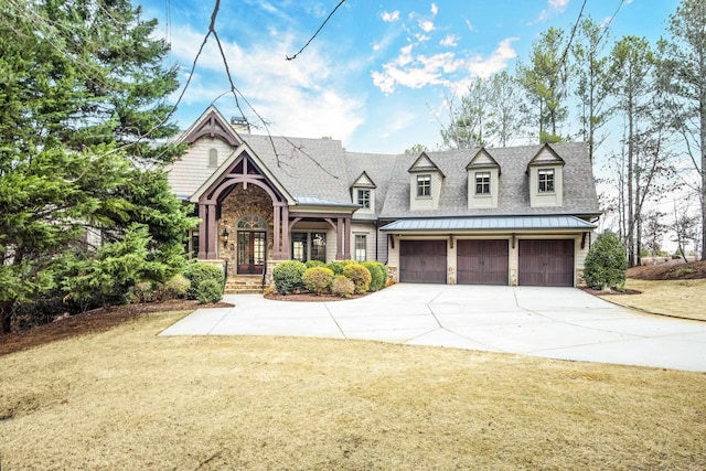 view of front of house featuring a garage and a front yard