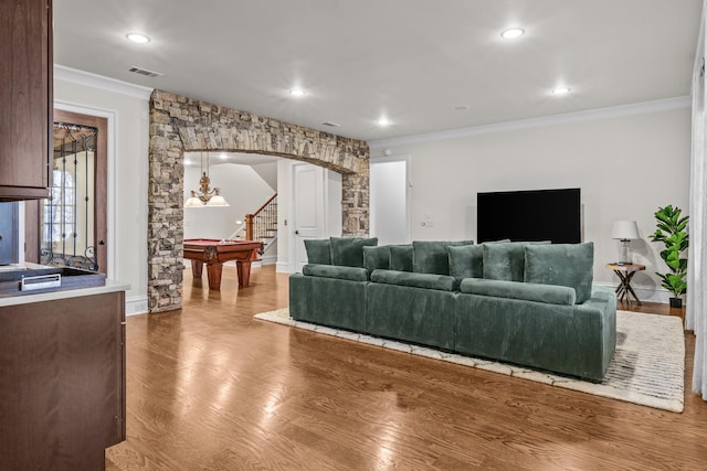 living room featuring hardwood / wood-style flooring and crown molding