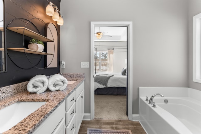 bathroom featuring vanity, hardwood / wood-style floors, and a bathing tub