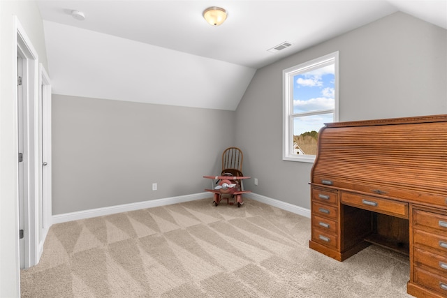 unfurnished office with light colored carpet and vaulted ceiling