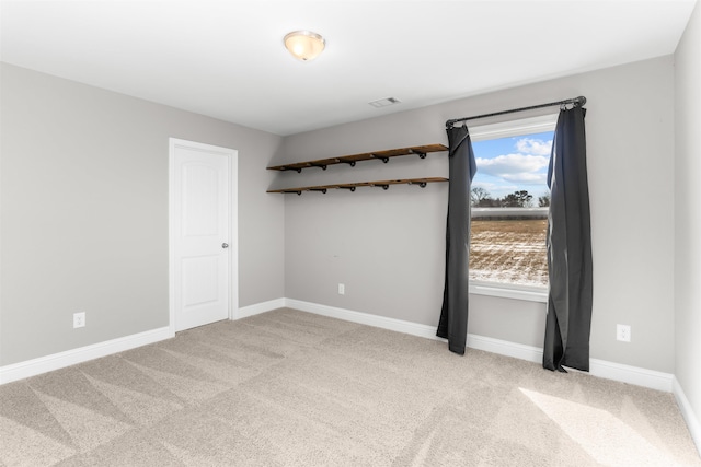 unfurnished room featuring light colored carpet